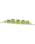 14K gold necklace with five round, medium light green Colombian emeralds, graduated in size.