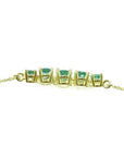 14K gold necklace with five round, medium light green Colombian emeralds, graduated in size.