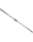 14K white gold paper clip bracelet with a rectangular emerald haloed by diamonds.