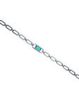 14K white gold paper clip bracelet with a rectangular emerald haloed by diamonds.