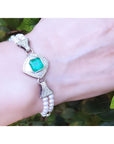18K white gold bracelet with a bezel-set Colombian emerald, diamonds, and double strands of pearls.