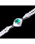 18K white gold emerald and pearl bracelet with a medium green emerald, diamonds, and two strands of pearls.