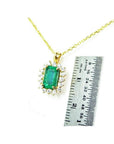 14K yellow gold emerald pendant with natural halo diamonds, shown next to a ruler for scale.