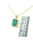 14K yellow gold emerald pendant with natural halo diamonds, shown next to a ruler for scale.