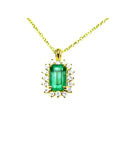 Gold necklace with a rectangular natural colombian emerald with halo diamond pendant on a topside position view.