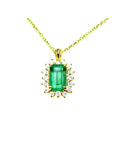 Gold necklace with a rectangular natural colombian emerald with halo diamond pendant on a topside position view.