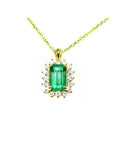 Gold necklace with a rectangular natural colombian emerald with halo diamond pendant on a topside position view.