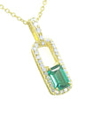 Gold necklace with a natural emerald-cut emerald pendant with a halo diamond, top and side profile visibles.