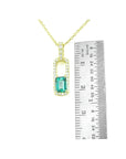18K yellow gold emerald-cut emerald and diamond halo pendant necklace, shown with ruler for size.