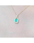 2.06 ct. emerald and natural diamond pendant in 18K yellow gold, worn on a woman's neck.