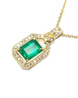 A 18k yellow gold necklace with an emerald and diamond pendant on a white background