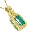 The right-side profile displayed of this 18k yellow gold emerald and diamonds accent pendant, the gallery profile view.