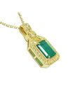 18K yellow gold emerald pendant with natural diamonds, rectangular emerald, and diamond-studded bail.