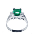 In this image an emerald and side baguette diamond platinum ring with top and gallery display.