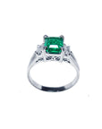 In this image an emerald and side baguette diamond platinum ring with top and gallery display.