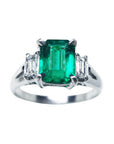 This three stone emerald platinum ring shows the topside with sides profile.