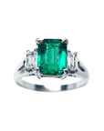 This three stone emerald platinum ring shows the topside with sides profile.