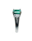 Platinum emerald ring on a side profile.