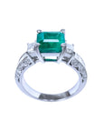 1.62 ct. square emerald ring with side princess cut diamonds on a 14K white gold band.