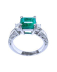 1.62 ct. square emerald ring with side princess cut diamonds on a 14K white gold band.