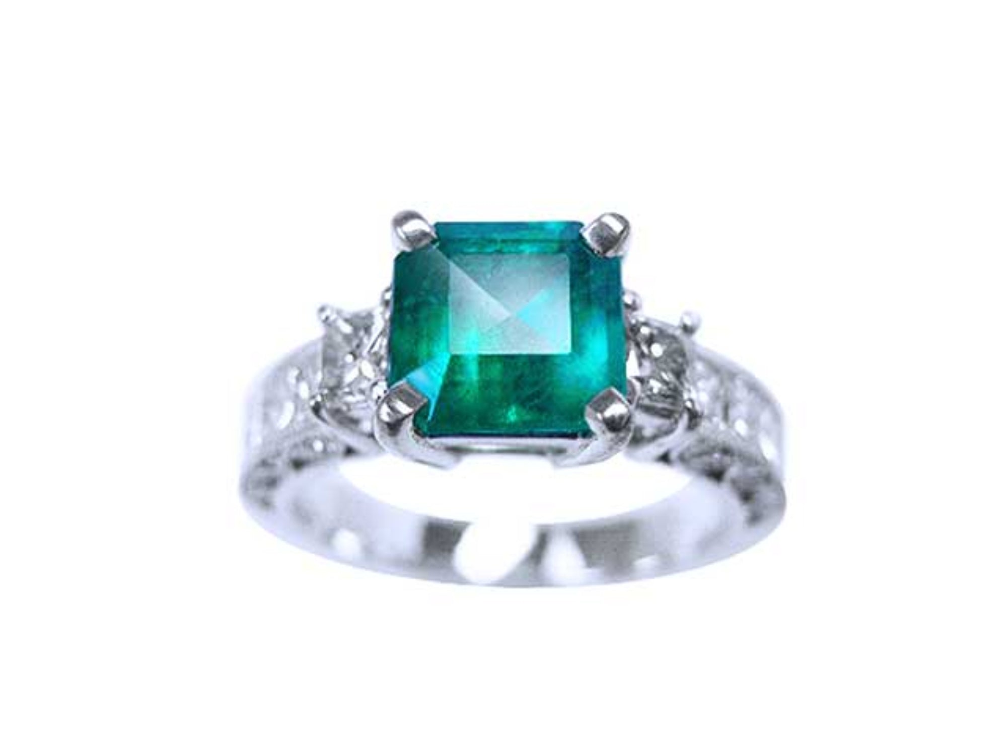 A real colombian emerald ring with side princess cut diamonds on front position displaying top and sideways band profile.