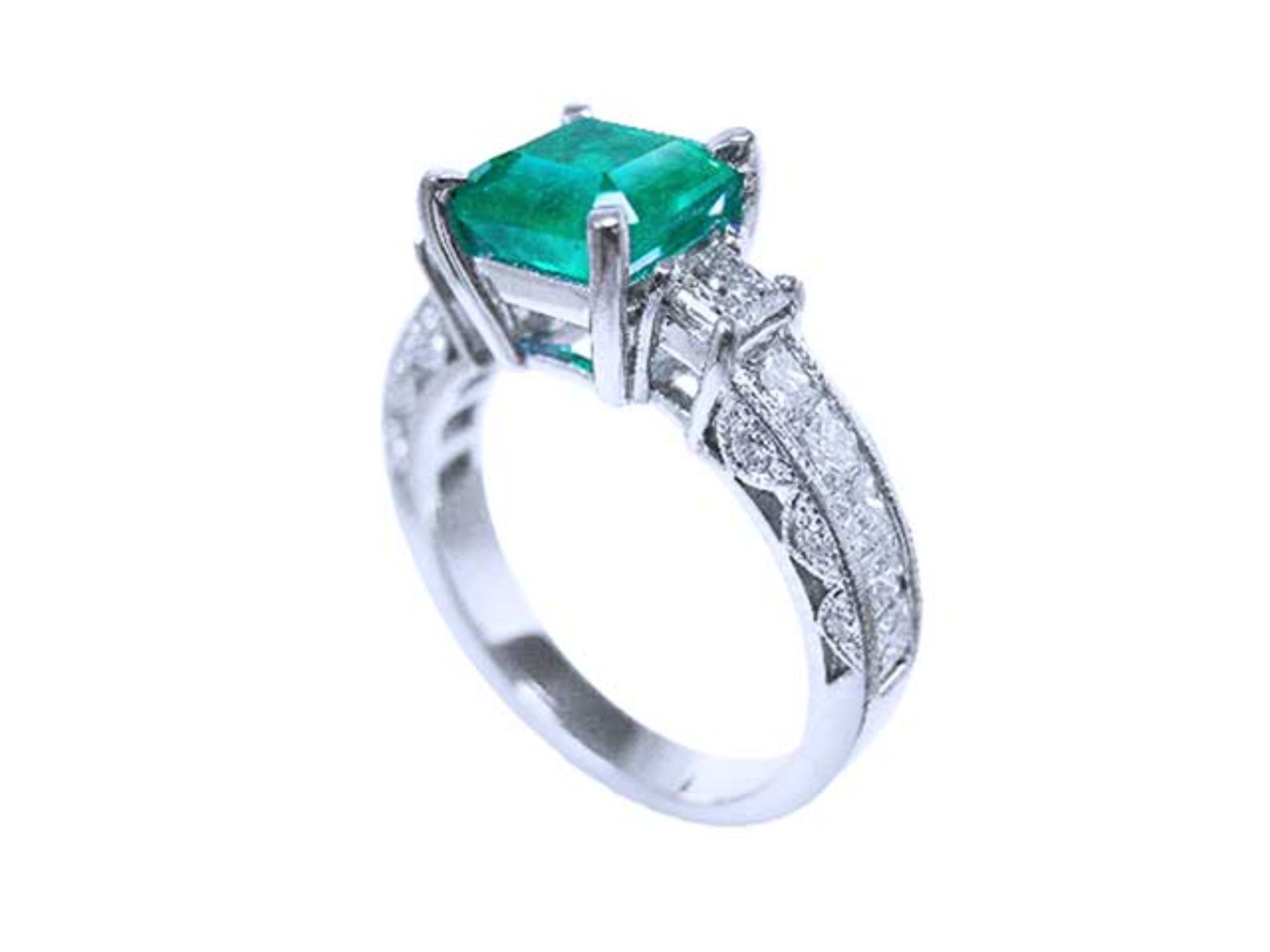 A vibrant emerald on top and side princess cut diamonds on the band of this ring are beautifully displayed.