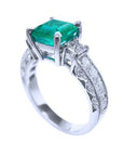 A vibrant emerald on top and side princess cut diamonds on the band of this ring are beautifully displayed.