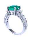 An emerald-cut real Colombian emerald ring on a half side positon, top and band profile visibles.
