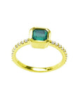 Bezel-set emerald ring with accent diamonds on a 14K yellow gold band.