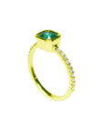 Bezel-set emerald ring with accent diamonds on a 14K yellow gold band.