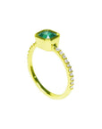 Bezel-set emerald ring with accent diamonds on a 14K yellow gold band.