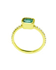 14K yellow gold ring with a bezel-set emerald and accent diamonds on the band.