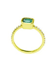 14K yellow gold ring with a bezel-set emerald and accent diamonds on the band.