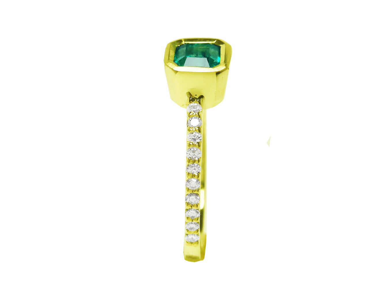 A top bezel setting with a colombian emerald and diamond-studded band on a white background.