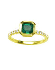 A natural colombian emerald ring with diamond accents made of 14k yellow gold.