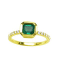 A natural colombian emerald ring with diamond accents made of 14k yellow gold.