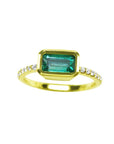 A yellow gold emerald ring bezel set with natural accent diamonds is the perfect gift as a May birthstone.