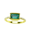 A yellow gold emerald ring bezel set with natural accent diamonds is the perfect gift as a May birthstone.