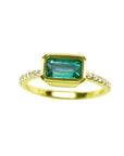 A yellow gold emerald ring bezel set with natural accent diamonds is the perfect gift as a May birthstone.