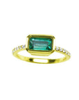 A yellow gold emerald ring bezel set with natural accent diamonds is the perfect gift as a May birthstone.