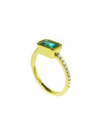 14K yellow gold east-west emerald ring, bezel set, with accent diamonds on the band.