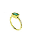 14K yellow gold east-west emerald ring, bezel set, with accent diamonds on the band.