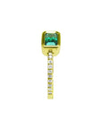 This bezel set emerald ring displays the top and side accent diamonds along the band in yellow gold.