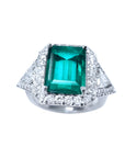 A natural colombian emerald ring with side trillion genuine diamond GIA certified, made of 18k white gold.