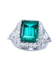 A natural colombian emerald ring with side trillion genuine diamond GIA certified, made of 18k white gold.