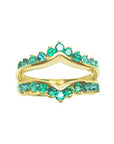 The topside view of an emerald ring guard in yellow gold.