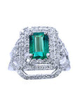 A front position of a Colombian emerald ring with double halo diamonds and matching band top view.