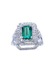 A front position of a Colombian emerald ring with double halo diamonds and matching band top view.