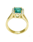 A yellow gold emerald ring on its lateral position that shows the top setting, gallery and band profiles.