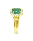 A yellow gold square emerald with halo diamond ring displaying the top and split shank side profile.